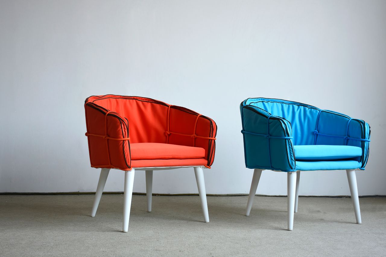 Modern orange and blue chairs against a minimalist background, showcasing unique design.