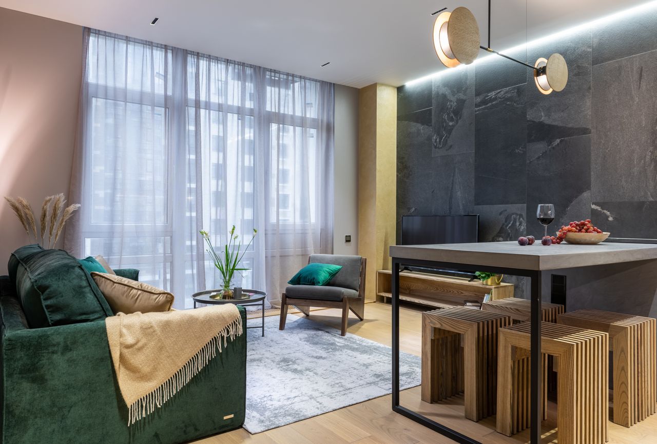 Contact Sleek and luxurious living room with modern furnishings and elegant decor.